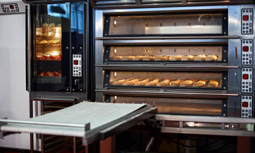 Industrial convection oven with cooked bakery products for catering. Professional kitchen equipment, Professional industrial equipment.